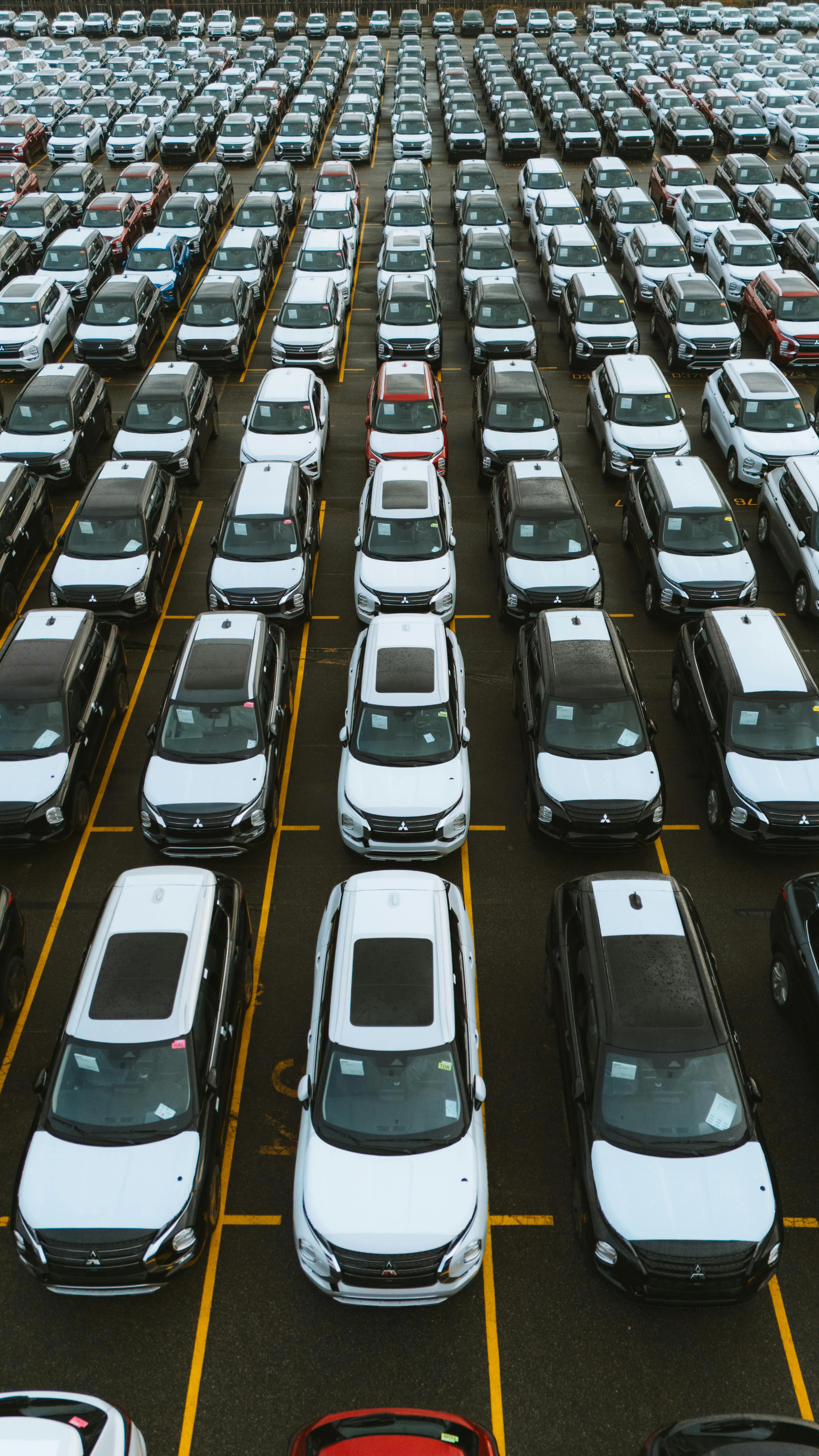 Aerial view of dealership inventory in rows on the lot
