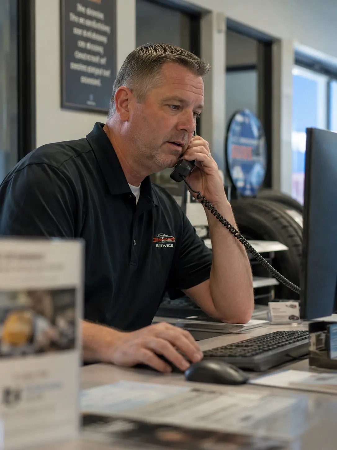 Service manager on a phone call at the service desk